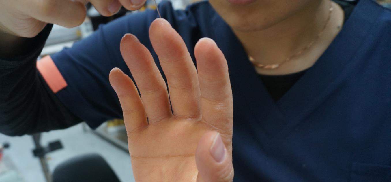 A silicone hand prosthesis being finished by hand